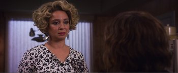 Movie still from “The Happytime Murders” (2018), directed by Brian Henson – A woman in a leopard print dress looking at a mirror; Close Up shot, Over the shoulder angle