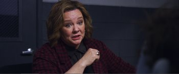 Movie still from “The Happytime Murders” (2018), directed by Brian Henson – A person wearing a suit and tie; Close Up shot, Over the shoulder angle