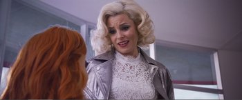 Movie still from “The Happytime Murders” (2018), directed by Brian Henson – A woman with blonde hair wearing a silver jacket; Close Up shot, Over the shoulder angle