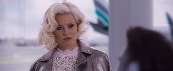 Movie still from “The Happytime Murders” (2018), directed by Brian Henson – A woman with blonde hair and a white lace top; Close Up shot, Over the shoulder angle