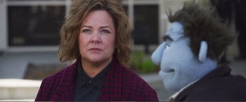 Movie still from “The Happytime Murders” (2018), directed by Brian Henson – A person wearing a suit and tie; Close Up shot, Over the shoulder angle