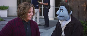 Movie still from “The Happytime Murders” (2018), directed by Brian Henson – A woman and a man wearing a suit and tie; Medium shot, Over the shoulder angle