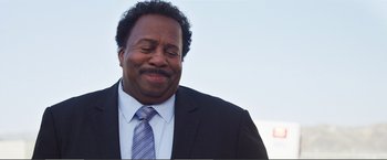 Movie still from “The Happytime Murders” (2018), directed by Brian Henson – A person wearing a suit and tie; Close Up shot, Low angle