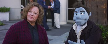Movie still from “The Happytime Murders” (2018), directed by Brian Henson – A woman standing next to a person wearing a costume; Medium shot, Over the shoulder angle