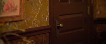 Movie still from “The Harder They Fall” (2021), directed by Jeymes Samuel – A door handle on a wooden door; Extreme Close Up shot, High angle