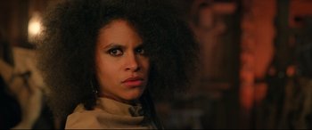 Movie still from “The Harder They Fall” (2021), directed by Jeymes Samuel – A person with a curly hair; Close Up shot, Low angle