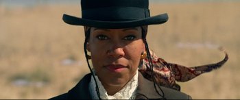 Movie still from “The Harder They Fall” (2021), directed by Jeymes Samuel – A person wearing a hat; Close Up shot, Low angle