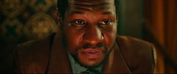 Movie still from “The Harder They Fall” (2021), directed by Jeymes Samuel – A man's face in a brown jacket; Close Up shot, Low angle