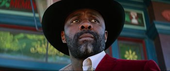 Movie still from “The Harder They Fall” (2021), directed by Jeymes Samuel – A person wearing a hat and a tie; Close Up shot, Low angle
