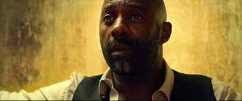 Movie still from “The Harder They Fall” (2021), directed by Jeymes Samuel – A person with a beard looking at the camera; Close Up shot, Low angle