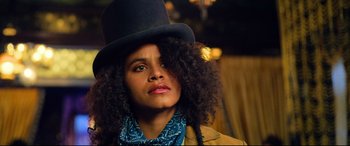 Movie still from “The Harder They Fall” (2021), directed by Jeymes Samuel – A woman in a top hat and a blue scarf; Close Up shot, Low angle