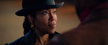 Movie still from “The Harder They Fall” (2021), directed by Jeymes Samuel – A person wearing a hat; Close Up shot, Over the shoulder angle