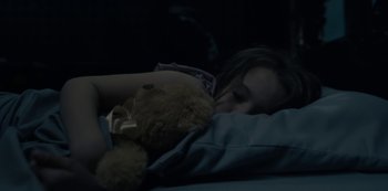 Movie still from “The Haunting of Hill House” (2018), directed by Mike Flanagan – A young girl sleeping with a teddy bear in her arms; Close Up shot, High angle