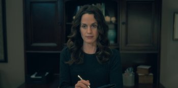 Movie still from “The Haunting of Hill House” (2018), directed by Mike Flanagan – A woman is writing on a piece of paper; Close Up shot, Over the shoulder angle