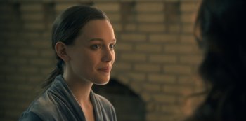 Movie still from “The Haunting of Hill House” (2018), directed by Mike Flanagan – A beautiful young lady looking to her left; Close Up shot, Over the shoulder angle