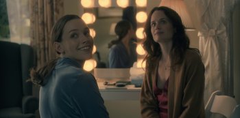 Movie still from “The Haunting of Hill House” (2018), directed by Mike Flanagan – Two women sitting in front of a mirror in a room; Medium shot, Over the shoulder angle