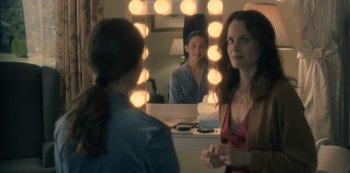 Movie still from “The Haunting of Hill House” (2018), directed by Mike Flanagan – Two women in front of a mirror in a dressing room; Medium shot, Over the shoulder angle