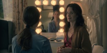 Movie still from “The Haunting of Hill House” (2018), directed by Mike Flanagan – Two women in front of a mirror in a dressing room; Medium shot, Over the shoulder angle