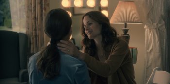 Movie still from “The Haunting of Hill House” (2018), directed by Mike Flanagan – A woman is touching the neck of another woman; Close Up shot, Over the shoulder angle