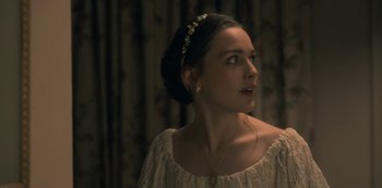 Movie still from “The Haunting of Hill House” (2018), directed by Mike Flanagan – A woman in a white dress looking to her left; Close Up shot, Over the shoulder angle