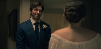 Movie still from “The Haunting of Hill House” (2018), directed by Mike Flanagan – A man in a suit looking at a woman in a white dress; Close Up shot, Over the shoulder angle