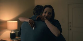 Movie still from “The Haunting of Hill House” (2018), directed by Mike Flanagan – A man and a woman hugging in a room; Medium shot, Over the shoulder angle