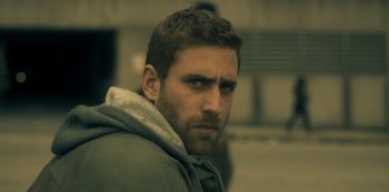 Movie still from “The Haunting of Hill House” (2018), directed by Mike Flanagan – A person wearing a jacket; Close Up shot, Over the shoulder angle