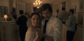 Movie still from “The Haunting of Hill House” (2018), directed by Mike Flanagan – A man and a woman posing for a picture; Close Up shot, Over the shoulder angle