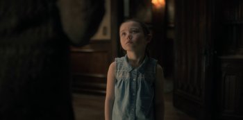 Movie still from “The Haunting of Hill House” (2018), directed by Mike Flanagan – A little girl standing in a room looking up; Medium shot, Over the shoulder angle