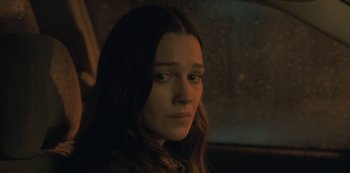 Movie still from “The Haunting of Hill House” (2018), directed by Mike Flanagan – A woman sitting in a car looking into the distance; Close Up shot, Low angle