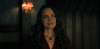 Movie still from “The Haunting of Hill House” (2018), directed by Mike Flanagan – A woman with long black curly hair wearing a red shirt; Close Up shot, Over the shoulder angle