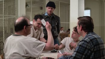 Movie still from “One Flew Over the Cuckoo's Nest” (1975), directed by Milos Forman – A group of men sitting around a table playing a card game; Medium shot, Over the shoulder angle