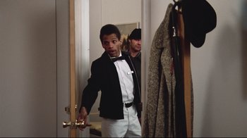 Movie still from “One Flew Over the Cuckoo's Nest” (1975), directed by Milos Forman – A young man in a tuxedo in front of a mirror; Medium shot, Over the shoulder angle