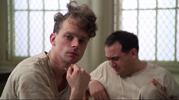 Movie still from “One Flew Over the Cuckoo's Nest” (1975), directed by Milos Forman – Two men sitting in front of each other in a room; Close Up shot, Low angle
