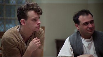Movie still from “One Flew Over the Cuckoo's Nest” (1975), directed by Milos Forman – Two men sitting in front of each other in a room; Close Up shot, Low angle