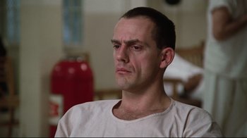 Movie still from “One Flew Over the Cuckoo's Nest” (1975), directed by Milos Forman – A person sitting in front of a fire hydrant; Close Up shot, Low angle