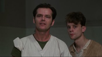 Movie still from “One Flew Over the Cuckoo's Nest” (1975), directed by Milos Forman – A man and a young man standing next to each other; Close Up shot, Low angle
