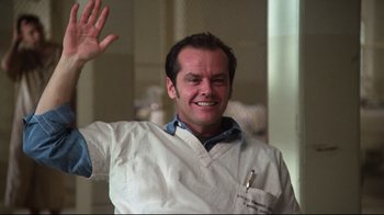 Movie still from “One Flew Over the Cuckoo's Nest” (1975), directed by Milos Forman – A man in white shirt waving at the camera; Medium shot, Low angle