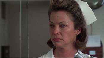 Movie still from “One Flew Over the Cuckoo's Nest” (1975), directed by Milos Forman – A person wearing a white shirt; Close Up shot, Low angle