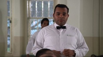 Movie still from “One Flew Over the Cuckoo's Nest” (1975), directed by Milos Forman – A man wearing a white shirt and a bow tie; Close Up shot, Low angle