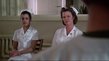 Movie still from “One Flew Over the Cuckoo's Nest” (1975), directed by Milos Forman – Two nurses are sitting in a hospital room; Medium shot, Low angle