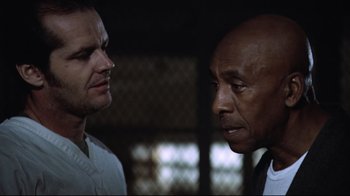 Movie still from “One Flew Over the Cuckoo's Nest” (1975), directed by Milos Forman – Two men standing next to each other in front of a window; Close Up shot, Low angle