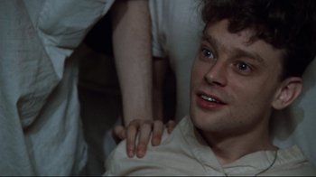 Movie still from “One Flew Over the Cuckoo's Nest” (1975), directed by Milos Forman – A man is being held down by another man; Close Up shot, High angle