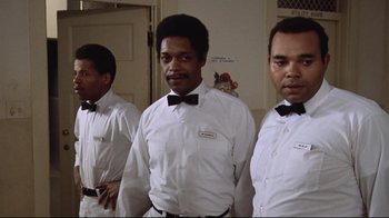 Movie still from “One Flew Over the Cuckoo's Nest” (1975), directed by Milos Forman – A group of men standing next to each other wearing ties; Medium shot, Low angle