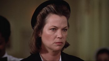 Movie still from “One Flew Over the Cuckoo's Nest” (1975), directed by Milos Forman – An older woman wearing a black hat and a black jacket; Close Up shot, Low angle