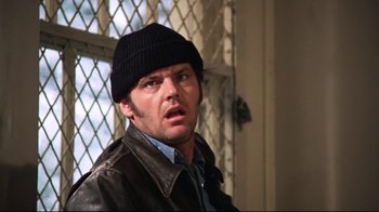 Movie still from “One Flew Over the Cuckoo's Nest” (1975), directed by Milos Forman – A man wearing a black hat and a leather jacket; Close Up shot, Low angle