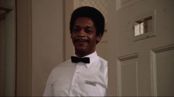 Movie still from “One Flew Over the Cuckoo's Nest” (1975), directed by Milos Forman – A man wearing a white shirt and a black bow tie; Close Up shot, Low angle