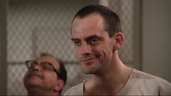 Movie still from “One Flew Over the Cuckoo's Nest” (1975), directed by Milos Forman – A person wearing glasses; Close Up shot, Low angle