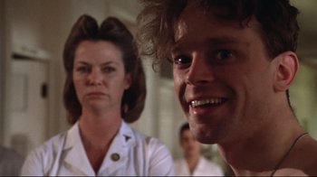 Movie still from “One Flew Over the Cuckoo's Nest” (1975), directed by Milos Forman – A man and a woman are smiling for the camera; Close Up shot, Low angle