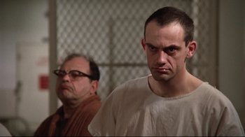 Movie still from “One Flew Over the Cuckoo's Nest” (1975), directed by Milos Forman – A man in a white shirt and a man in a tan shirt; Close Up shot, Low angle